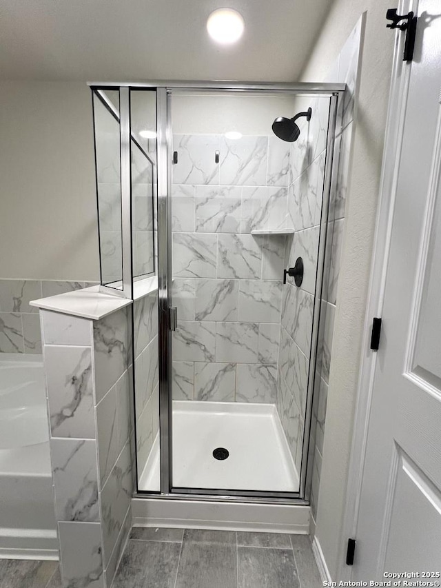 bathroom featuring tile patterned floors and an enclosed shower