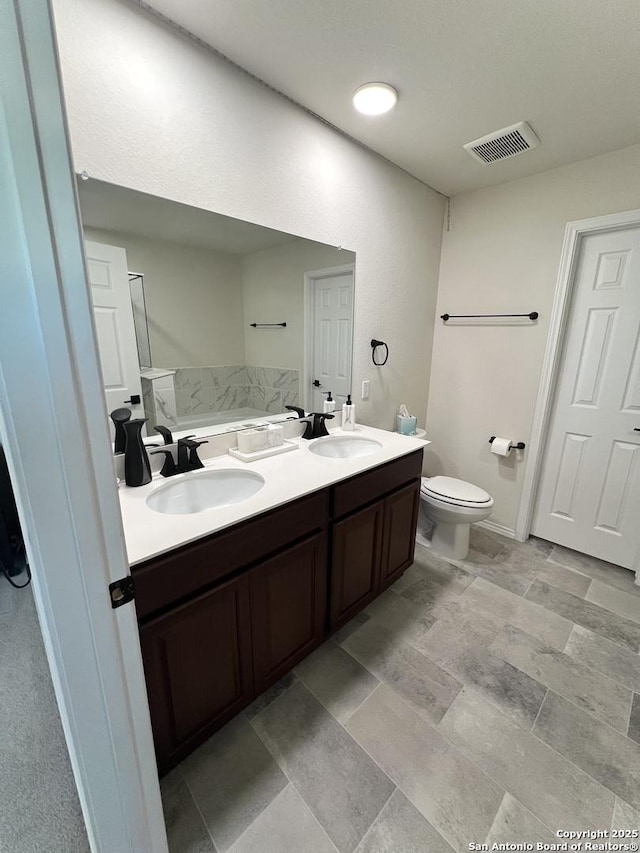 bathroom with vanity and toilet