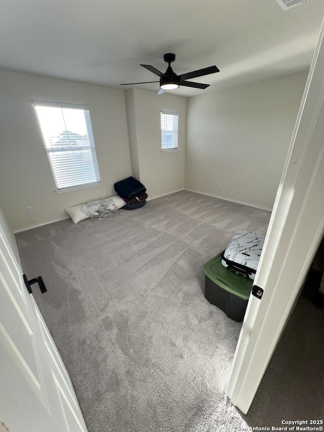 interior space with ceiling fan and carpet floors