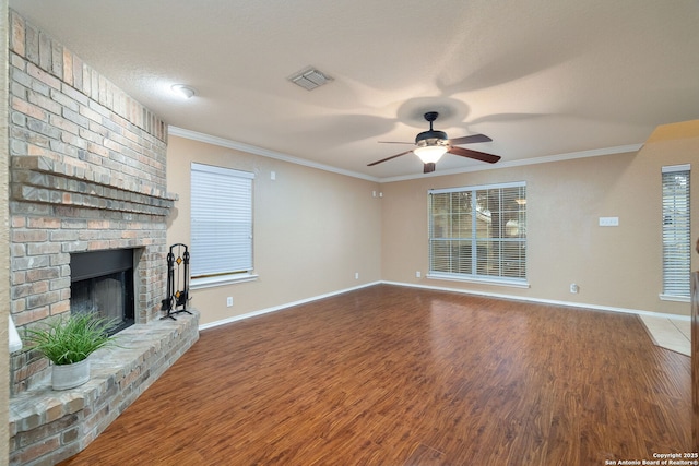 unfurnished living room with crown molding, a fireplace, ceiling fan, and hardwood / wood-style flooring