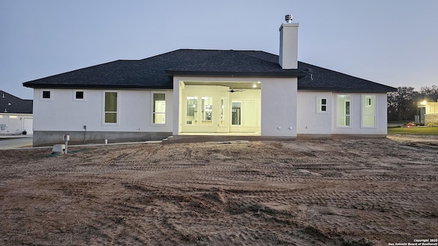 back house at dusk with ceiling fan