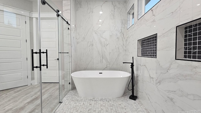 bathroom with tile patterned floors and a washtub