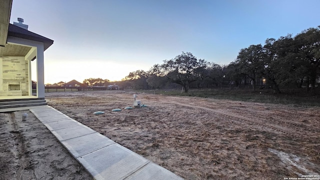 view of yard at dusk