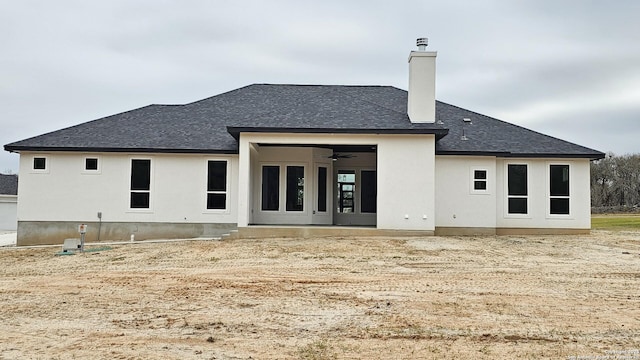 rear view of house featuring ceiling fan