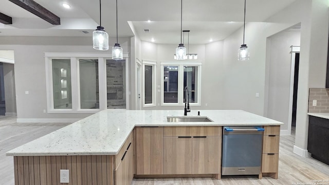 kitchen featuring light stone countertops, beamed ceiling, decorative backsplash, sink, and hanging light fixtures