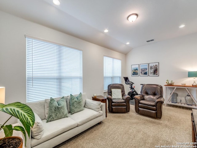 living room with a wealth of natural light, carpet floors, and lofted ceiling