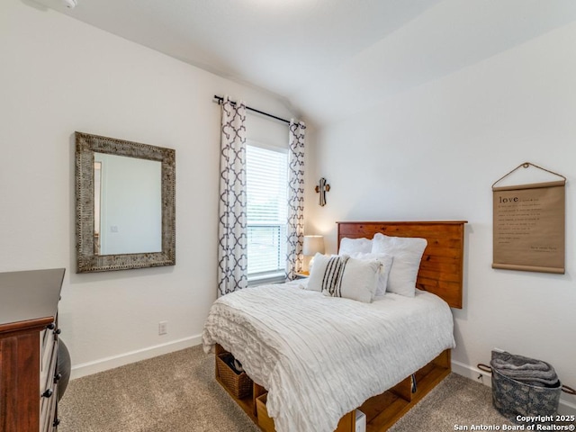 bedroom featuring carpet and vaulted ceiling