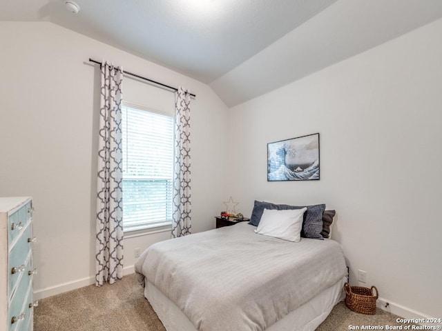 bedroom featuring multiple windows, carpet floors, and vaulted ceiling