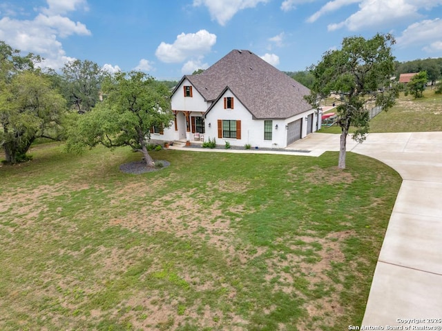 view of front facade with a front yard and a garage