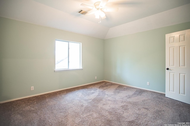 empty room featuring ceiling fan, carpet, and vaulted ceiling