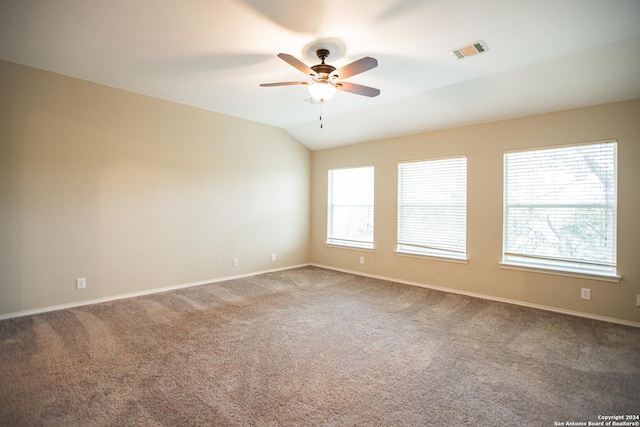 carpeted spare room featuring ceiling fan and lofted ceiling