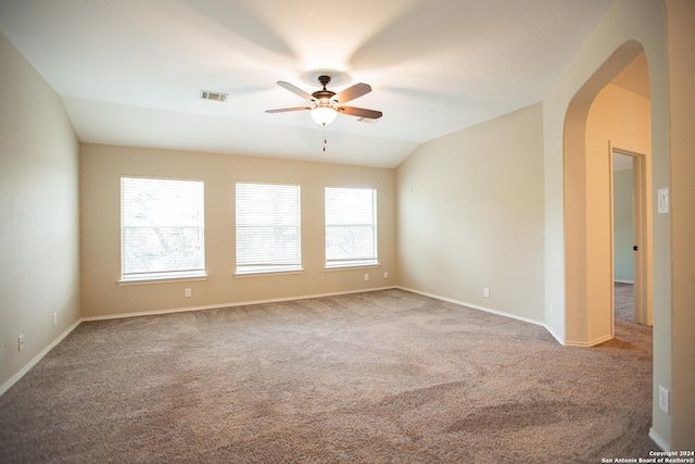 carpeted empty room featuring ceiling fan and vaulted ceiling