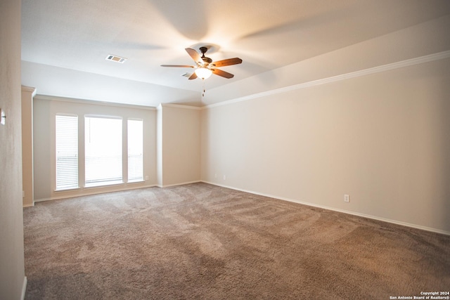 spare room with carpet, ceiling fan, ornamental molding, and lofted ceiling