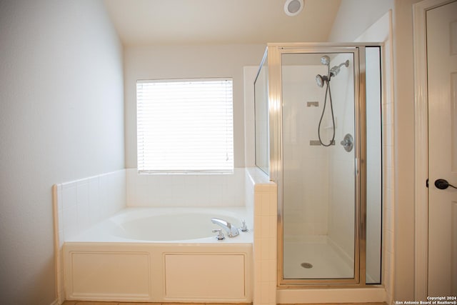 bathroom featuring independent shower and bath