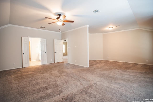 empty room with ceiling fan, light colored carpet, lofted ceiling, and crown molding