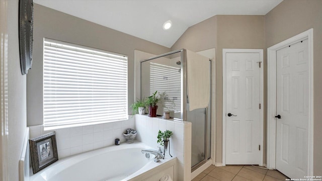 bathroom with tile patterned flooring, plus walk in shower, and vaulted ceiling