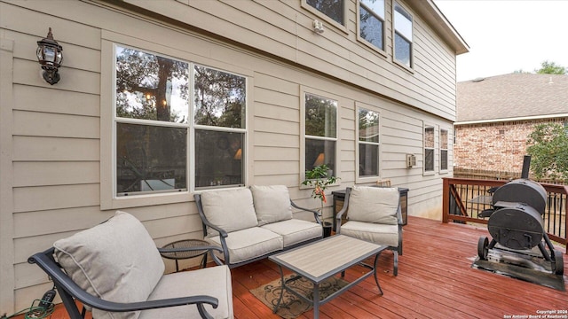 wooden terrace with an outdoor hangout area