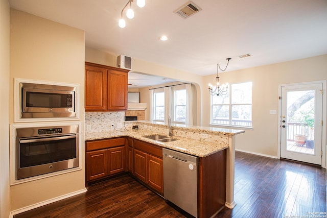 kitchen with an inviting chandelier, sink, plenty of natural light, kitchen peninsula, and stainless steel appliances