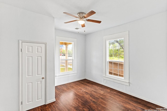 spare room with ceiling fan and dark hardwood / wood-style flooring