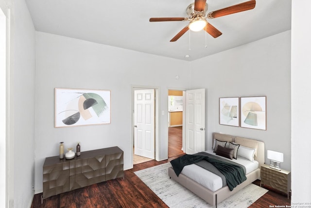 bedroom with dark hardwood / wood-style flooring and ceiling fan