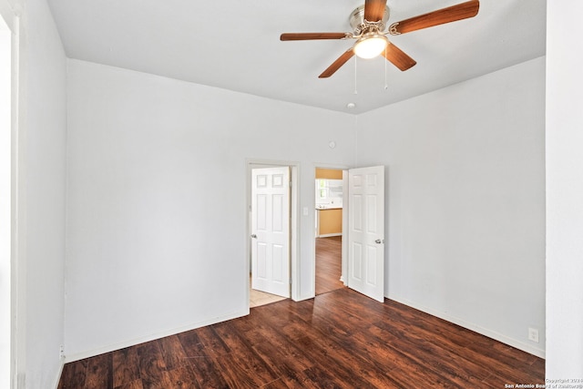 unfurnished room with dark hardwood / wood-style floors and ceiling fan