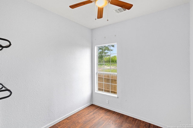 unfurnished room featuring ceiling fan and dark wood-type flooring