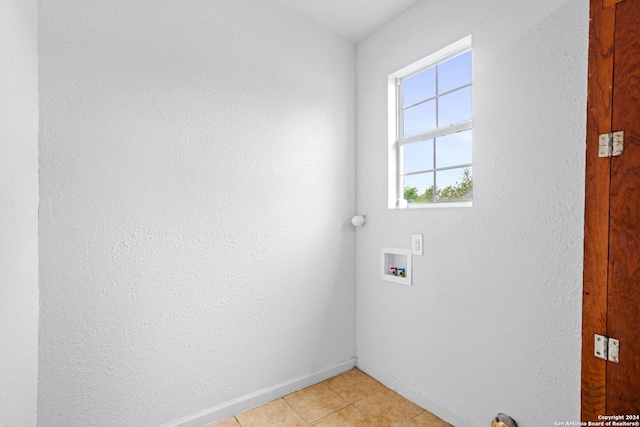 laundry area with hookup for a washing machine and light tile patterned floors