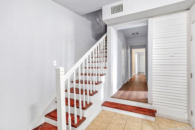 staircase with tile patterned floors