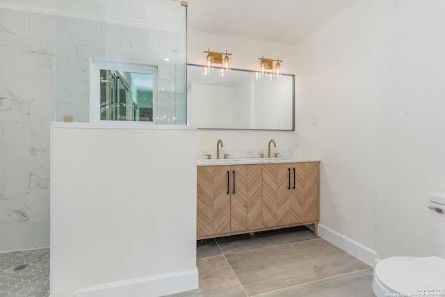 bathroom featuring vanity, toilet, and a shower