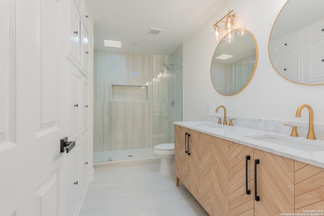 bathroom featuring vanity, toilet, and walk in shower