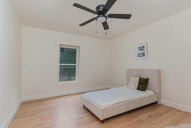 bedroom featuring light hardwood / wood-style flooring and ceiling fan