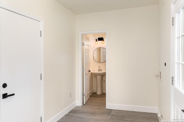 hallway with light hardwood / wood-style floors and sink