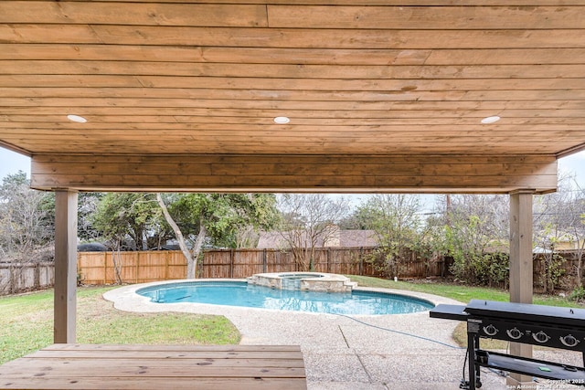 view of pool with a grill and an in ground hot tub