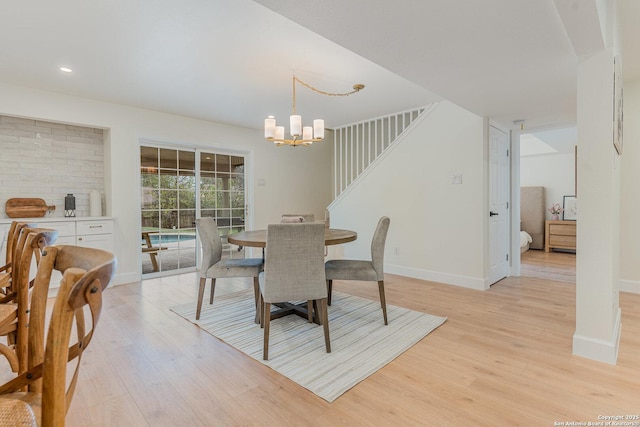 dining room featuring light hardwood / wood-style flooring and a chandelier