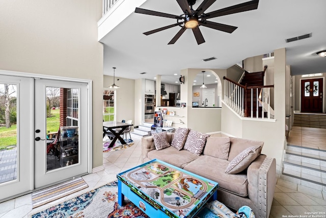 living room featuring ceiling fan, french doors, and light tile patterned floors