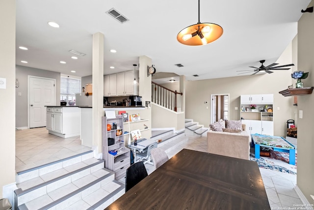 tiled dining space featuring ceiling fan