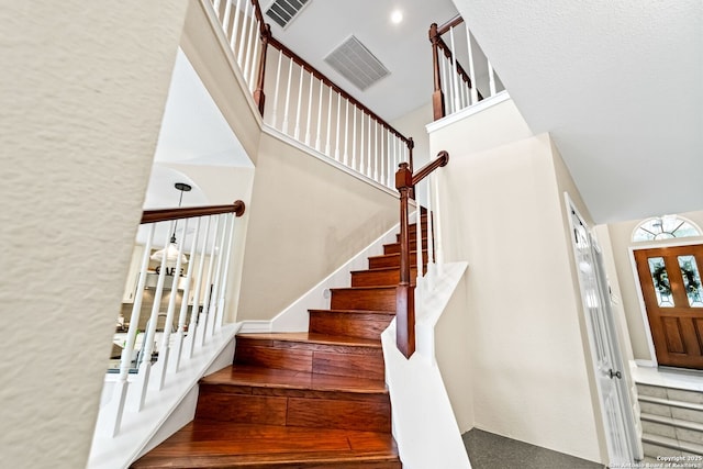 entryway featuring a towering ceiling