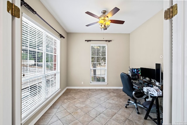 tiled home office with ceiling fan and plenty of natural light