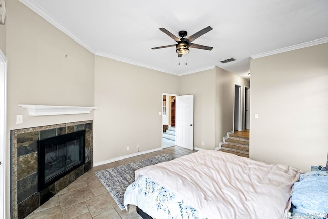 bedroom featuring ceiling fan, a fireplace, and crown molding