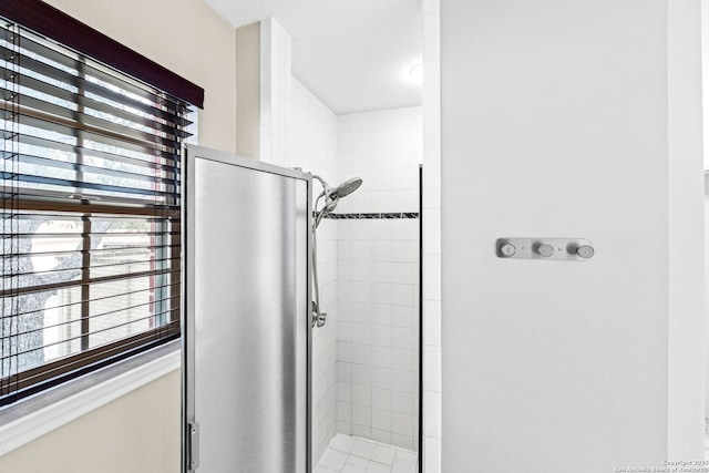 bathroom with a shower with door