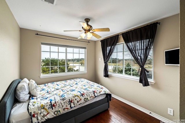 bedroom featuring ceiling fan and dark hardwood / wood-style flooring