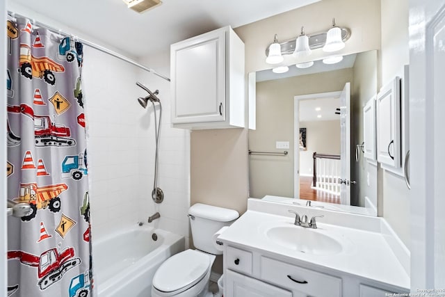 full bathroom featuring water heater, shower / tub combo with curtain, vanity, and toilet