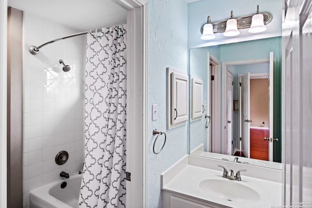 bathroom featuring shower / tub combo with curtain and vanity