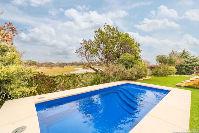 view of pool with a lawn