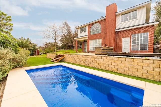 view of pool featuring a yard