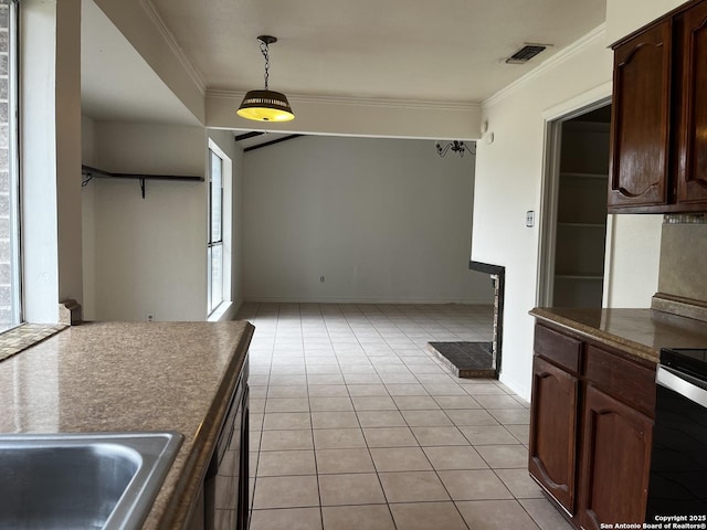 kitchen with range with electric cooktop, hanging light fixtures, ornamental molding, light tile patterned floors, and dark brown cabinets