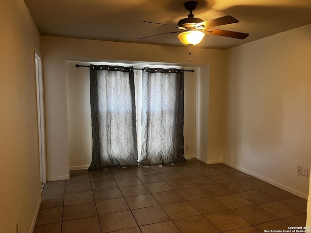 spare room with tile patterned floors and ceiling fan