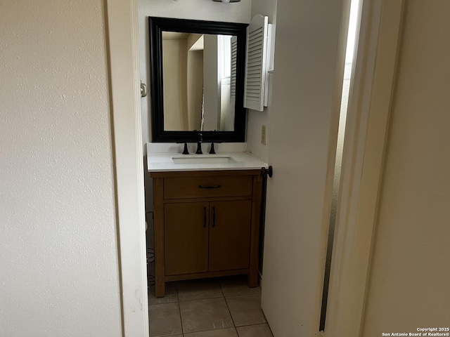 bathroom with tile patterned flooring and vanity