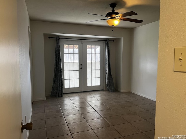 unfurnished room with tile patterned floors, ceiling fan, and french doors