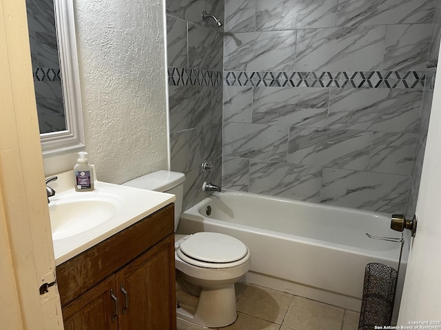 full bathroom featuring tile patterned floors, tiled shower / bath, vanity, and toilet